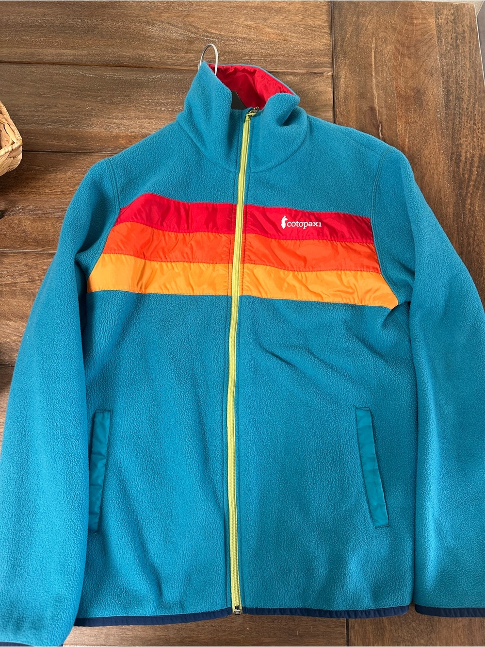 cotopaxi teal kids fleece jacket with red and orange stripe